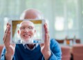 Portrait of happy senior man taking self portrait through digital tablet in nursing home